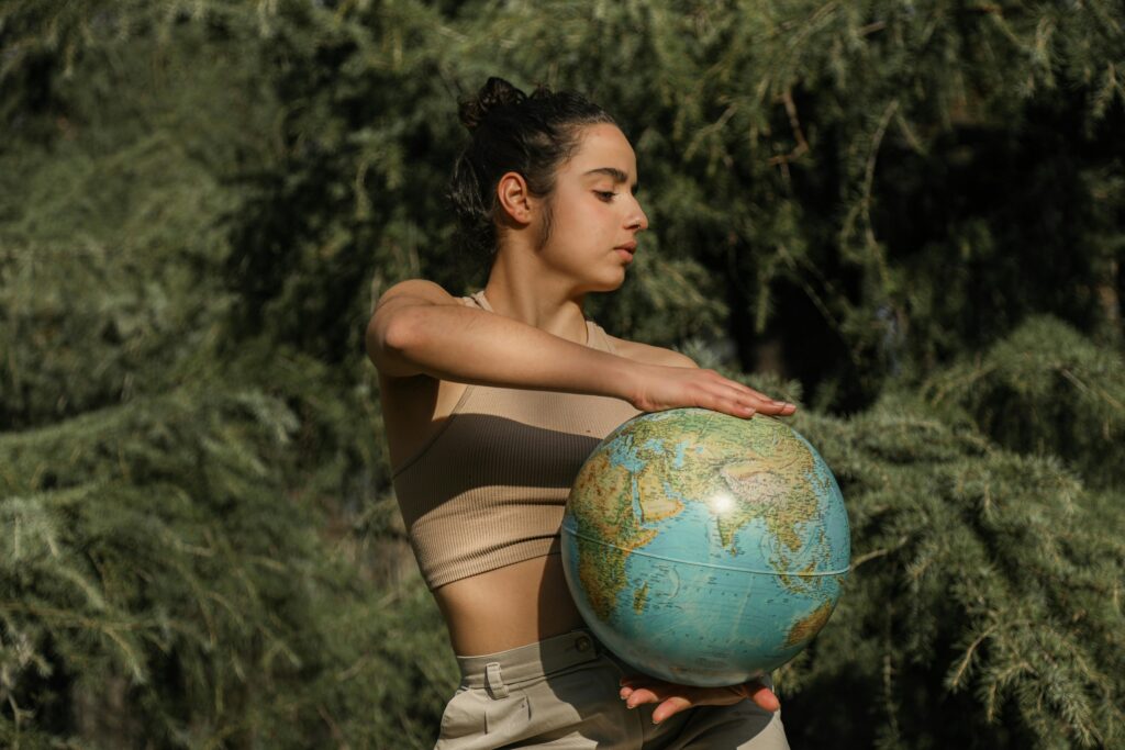 a-girl-supporting-sustainable-fashion-holding-a-globe